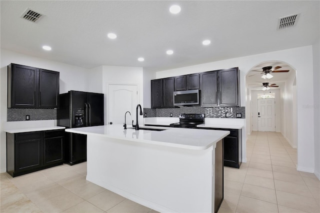 1565 Diamond Loop Dr, Kissimmee, FL 34744 - kitchen with black appliances, a ceiling fan, decorative backsplash, light countertops, and recessed lighting