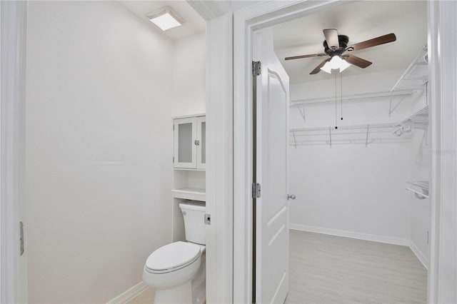 1565 Diamond Loop Dr, Kissimmee, FL 34744 - bathroom featuring ceiling fan, wood finished floors, and a spacious closet