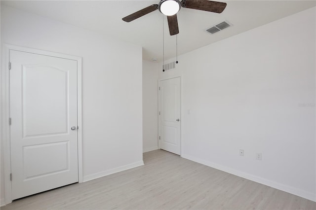 1565 Diamond Loop Dr, Kissimmee, FL 34744 - unfurnished bedroom featuring light wood finished floors and a ceiling fan
