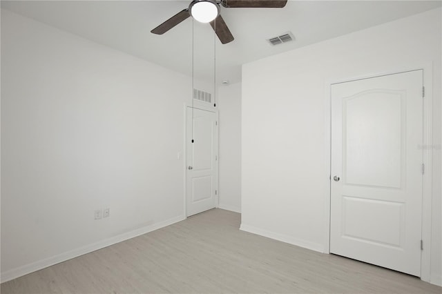 1565 Diamond Loop Dr, Kissimmee, FL 34744 - unfurnished bedroom featuring light wood-style floors and ceiling fan