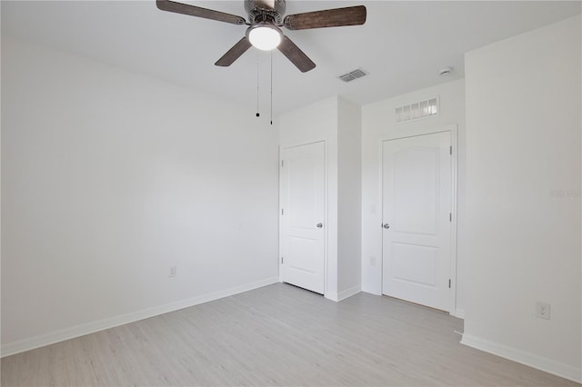 1565 Diamond Loop Dr, Kissimmee, FL 34744 - unfurnished bedroom with wood finished floors and a ceiling fan
