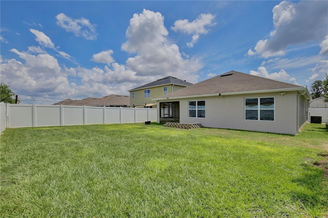 1565 Diamond Loop Dr, Kissimmee, FL 34744 - rear view of property featuring stucco siding, a fenced backyard, and a sunroom
