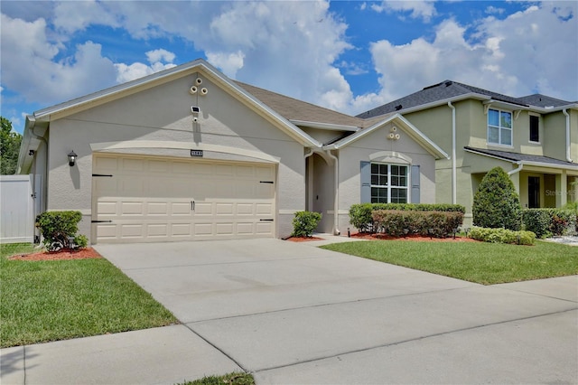 1565 Diamond Loop Dr, Kissimmee, FL 34744 - view of front of home with a garage, stucco siding, concrete driveway, and a front yard