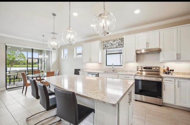 13084 Rinella St, Venice, FL 34293 - kitchen with appliances with stainless steel finishes, under cabinet range hood, a center island, crown molding, and plenty of natural light