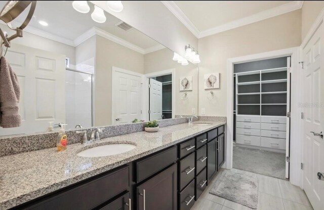 13084 Rinella St, Venice, FL 34293 - full bath with a shower stall, double vanity, ornamental molding, tile patterned flooring, and a walk in closet
