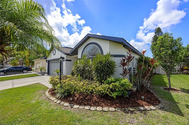14566 Quail Trail Cir, Orlando, FL 32837 - view of front of property with driveway, a front lawn, stucco siding, and a garage
