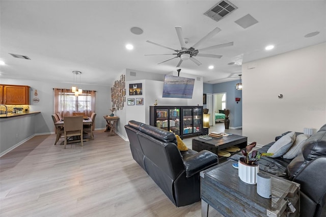 14566 Quail Trail Cir, Orlando, FL 32837 - living room with ceiling fan, light wood-style floors, recessed lighting, and a chandelier