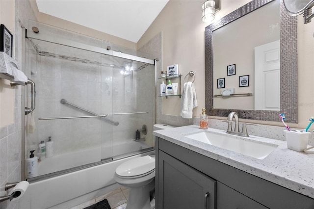 14566 Quail Trail Cir, Orlando, FL 32837 - bathroom featuring vanity, combined bath / shower with glass door, lofted ceiling, and tile patterned floors
