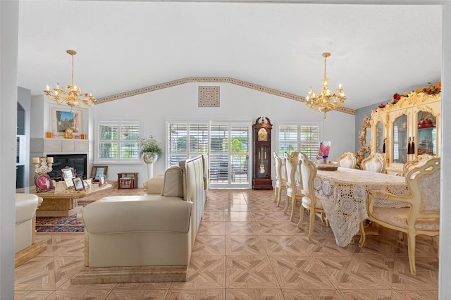 2076 Shannon Lakes Blvd, Kissimmee, FL 34743 - dining room featuring a chandelier, healthy amount of natural light, vaulted ceiling, and a tile fireplace