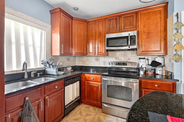 2076 Shannon Lakes Blvd, Kissimmee, FL 34743 - kitchen with stainless steel appliances, dark stone counters, backsplash, brown cabinets, and a textured ceiling