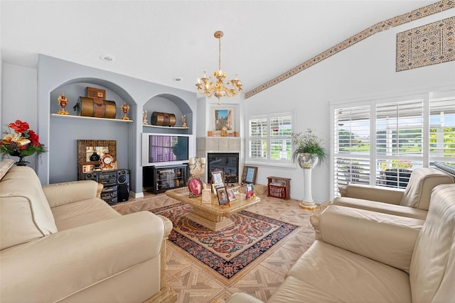 2076 Shannon Lakes Blvd, Kissimmee, FL 34743 - living room featuring a chandelier, built in features, high vaulted ceiling, and a fireplace