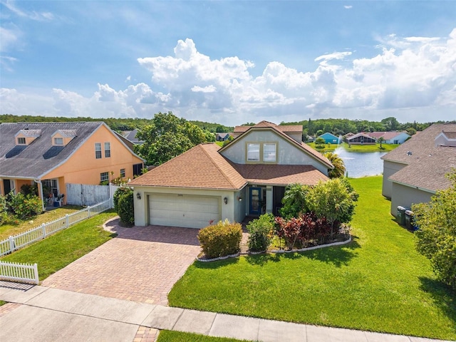 2076 Shannon Lakes Blvd, Kissimmee, FL 34743 - traditional-style home with decorative driveway, stucco siding, an attached garage, and a residential view