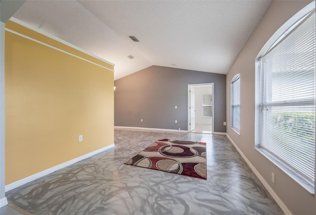 10675 Fairhaven Way, Orlando, FL 32825 - empty room featuring vaulted ceiling and a textured ceiling