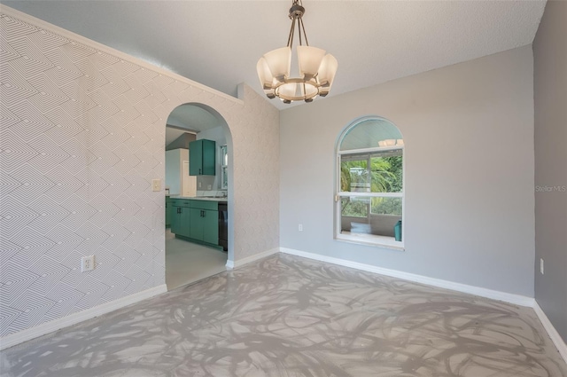 10675 Fairhaven Way, Orlando, FL 32825 - carpeted empty room with a chandelier, arched walkways, and lofted ceiling