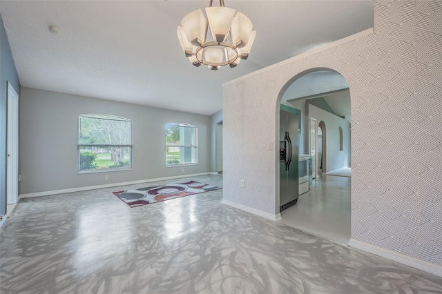10675 Fairhaven Way, Orlando, FL 32825 - spare room with arched walkways, a chandelier, and a smoke detector