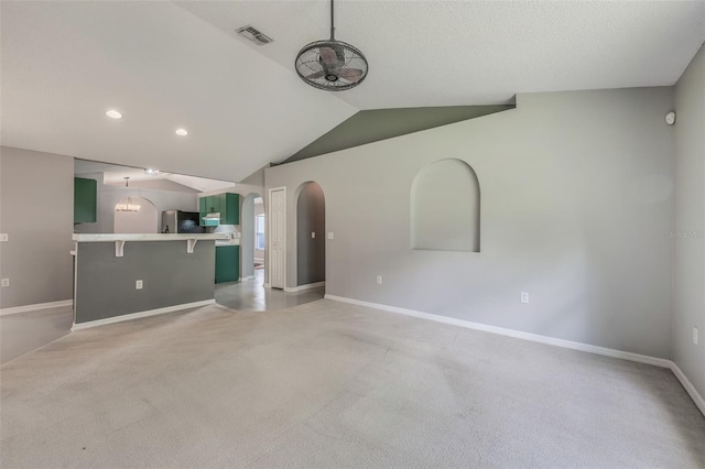 10675 Fairhaven Way, Orlando, FL 32825 - unfurnished living room with lofted ceiling, arched walkways, light carpet, and recessed lighting