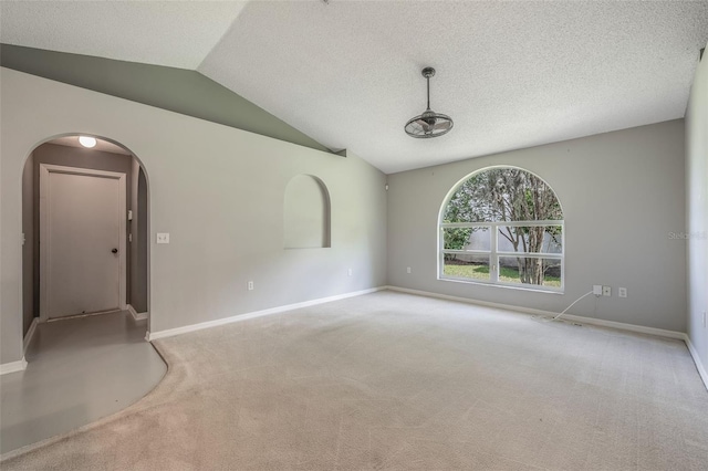 10675 Fairhaven Way, Orlando, FL 32825 - carpeted empty room with vaulted ceiling, arched walkways, and a textured ceiling