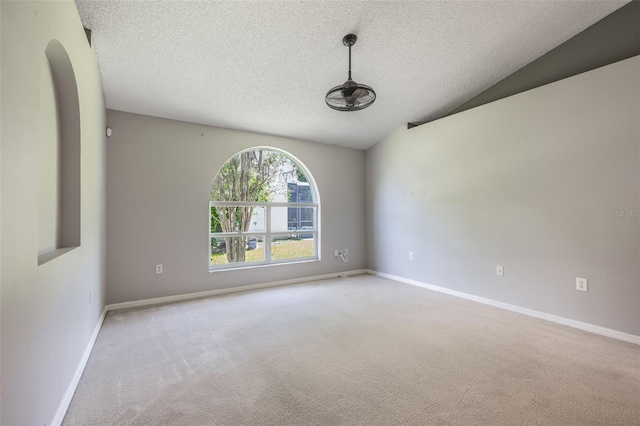 10675 Fairhaven Way, Orlando, FL 32825 - empty room with carpet, a textured ceiling, and arched walkways