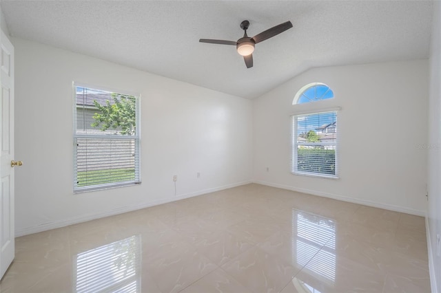 10675 Fairhaven Way, Orlando, FL 32825 - empty room featuring vaulted ceiling, light tile patterned floors, ceiling fan, and a textured ceiling