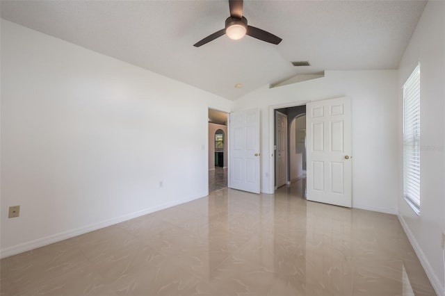 10675 Fairhaven Way, Orlando, FL 32825 - unfurnished bedroom featuring vaulted ceiling, multiple windows, and ceiling fan