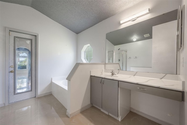 10675 Fairhaven Way, Orlando, FL 32825 - bathroom featuring vaulted ceiling, a bath, vanity, a shower stall, and a textured ceiling