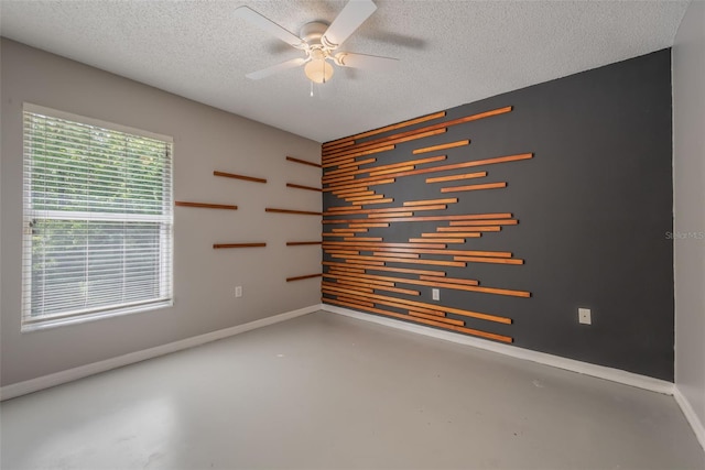 10675 Fairhaven Way, Orlando, FL 32825 - unfurnished room with finished concrete floors, ceiling fan, and a textured ceiling