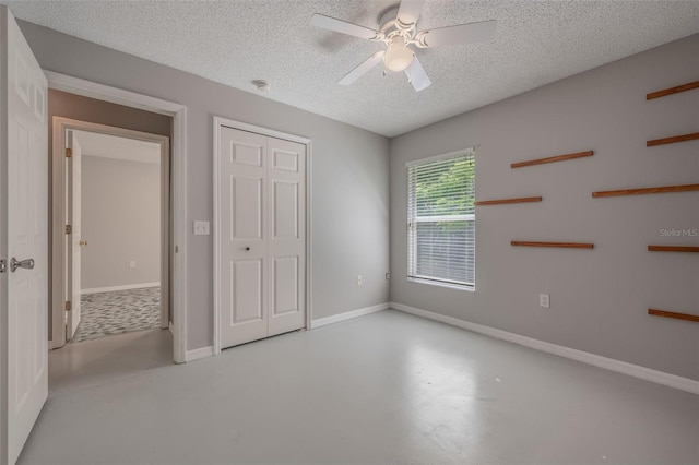 10675 Fairhaven Way, Orlando, FL 32825 - unfurnished bedroom featuring concrete flooring, a textured ceiling, ceiling fan, and a closet