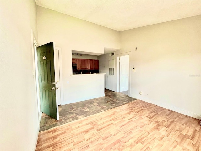 5500 Devonbriar Way Unit 202, Orlando, FL 32822 - unfurnished living room featuring wood finished floors and high vaulted ceiling