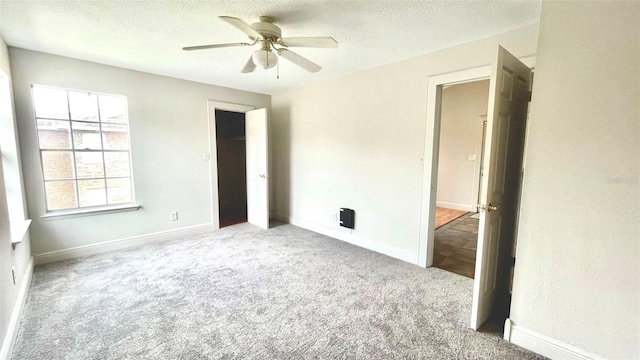 5500 Devonbriar Way Unit 202, Orlando, FL 32822 - unfurnished bedroom featuring carpet flooring, a textured ceiling, and ceiling fan