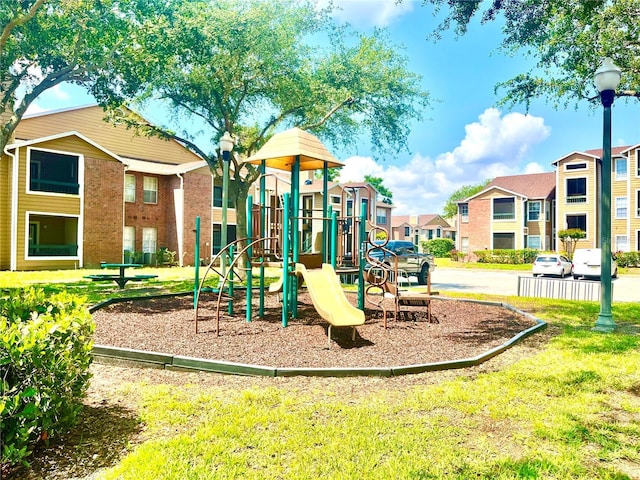 5500 Devonbriar Way Unit 202, Orlando, FL 32822 - community playground featuring a residential view and a lawn