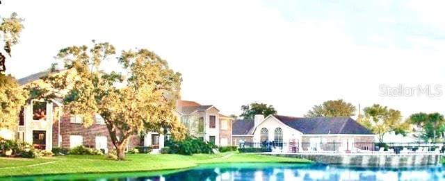 5500 Devonbriar Way Unit 202, Orlando, FL 32822 - view of swimming pool with a lawn