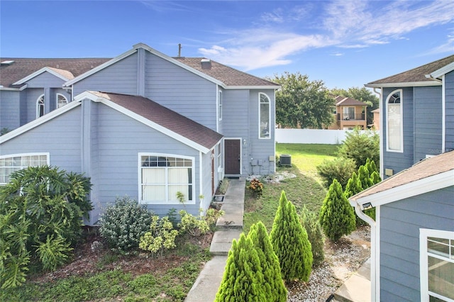 709 Orchid Dr, Davenport, FL 33897 - view of side of home with roof with shingles and a cooling unit