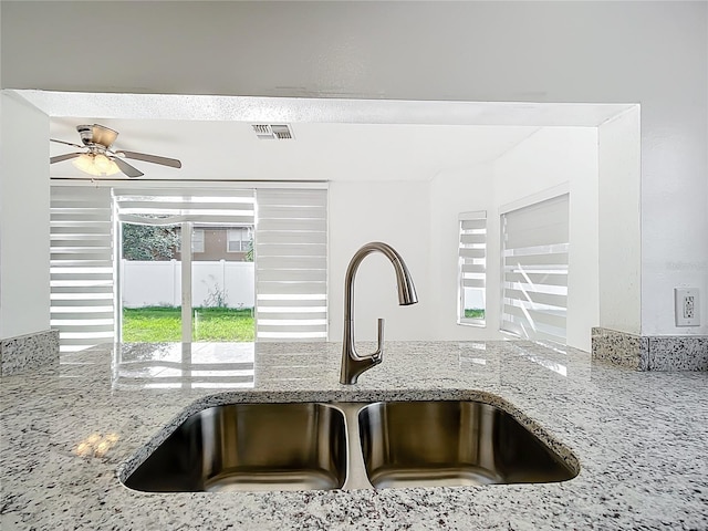 709 Orchid Dr, Davenport, FL 33897 - kitchen view of light stone countertops and a ceiling fan