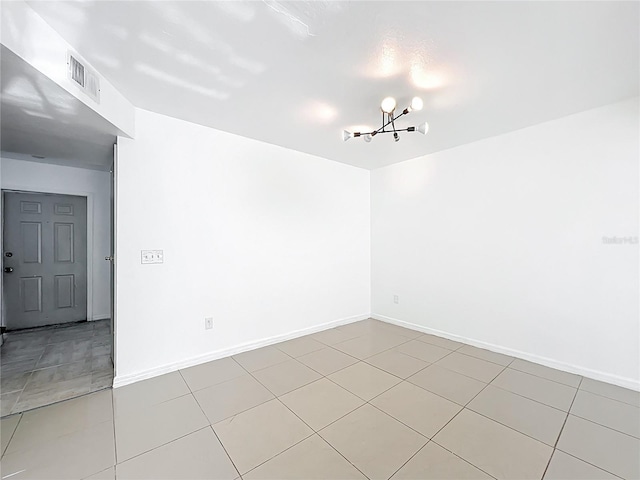 709 Orchid Dr, Davenport, FL 33897 - spare room with a chandelier and light tile patterned floors