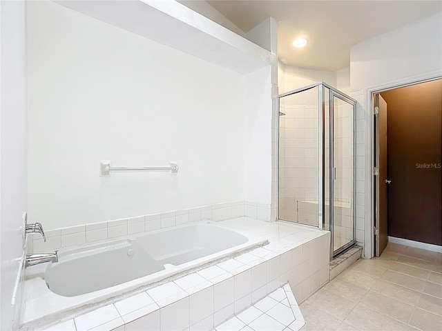 709 Orchid Dr, Davenport, FL 33897 - bathroom with a garden tub, a shower stall, and tile patterned floors