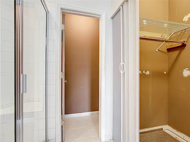 709 Orchid Dr, Davenport, FL 33897 - bathroom with tile patterned flooring and an enclosed shower