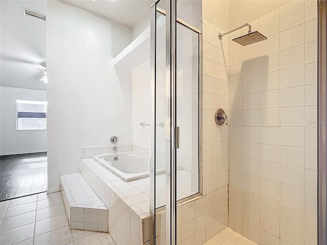 709 Orchid Dr, Davenport, FL 33897 - full bath with a stall shower, a garden tub, tile patterned flooring, and a ceiling fan