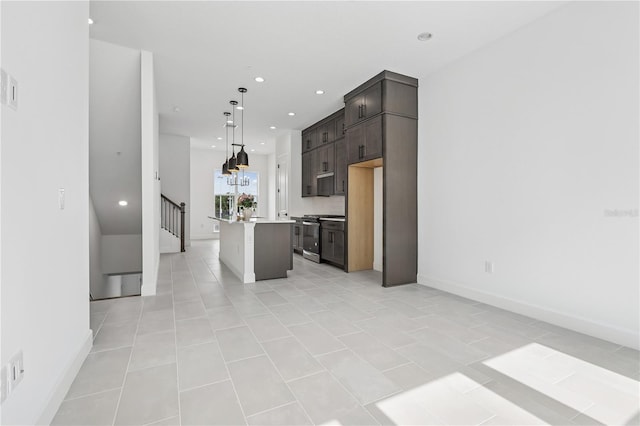 2018 Packing District Way, Orlando, FL 32804 - kitchen with recessed lighting, stainless steel gas range oven, a kitchen island, dark brown cabinetry, and open floor plan