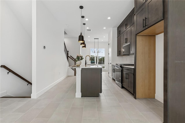 2018 Packing District Way, Orlando, FL 32804 - kitchen featuring gas range, a kitchen island with sink, recessed lighting, light countertops, and hanging light fixtures