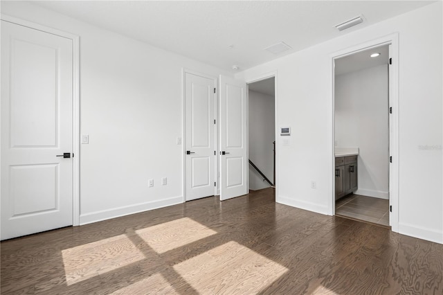 2018 Packing District Way, Orlando, FL 32804 - unfurnished bedroom featuring wood finished floors and ensuite bath
