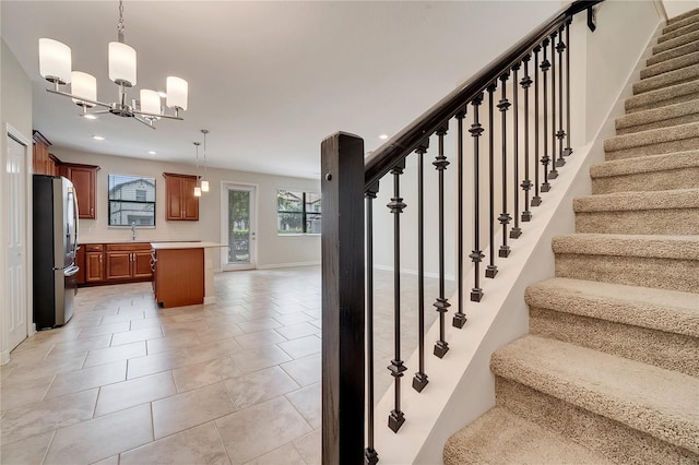 1246 Payne Stewart Dr, Davenport, FL 33896 - stairway featuring a chandelier, tile patterned flooring, and recessed lighting