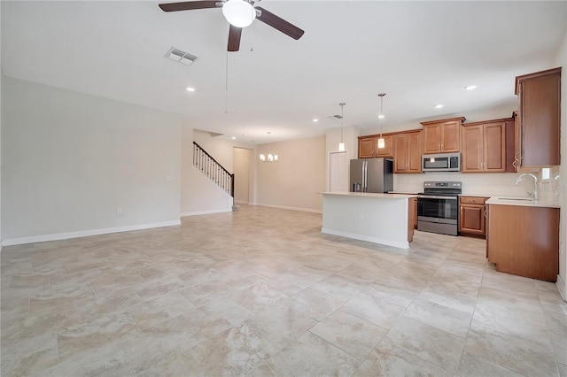 1246 Payne Stewart Dr, Davenport, FL 33896 - kitchen with appliances with stainless steel finishes, open floor plan, a center island, light countertops, and recessed lighting