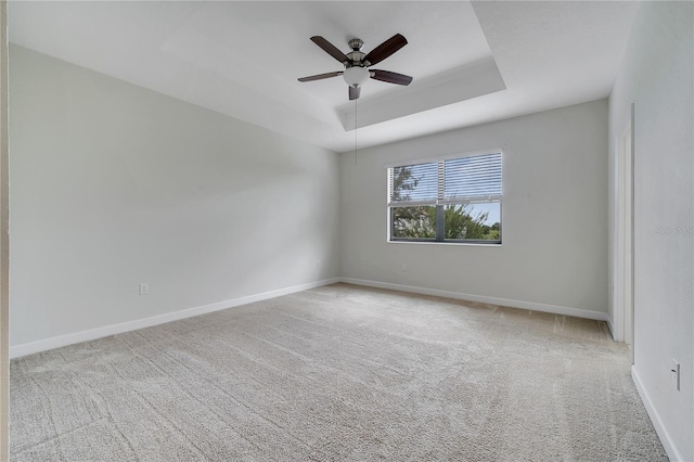 1246 Payne Stewart Dr, Davenport, FL 33896 - spare room featuring carpet, a tray ceiling, and a ceiling fan