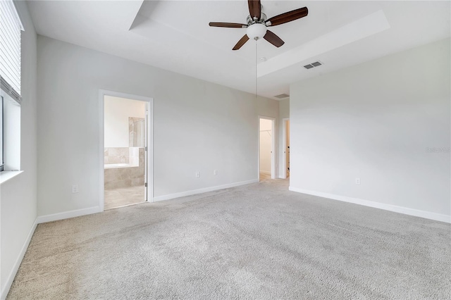1246 Payne Stewart Dr, Davenport, FL 33896 - unfurnished room with a raised ceiling, a ceiling fan, and carpet