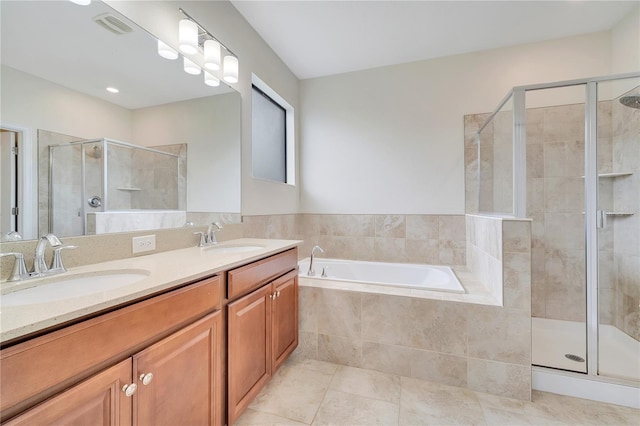1246 Payne Stewart Dr, Davenport, FL 33896 - bathroom featuring a stall shower, a garden tub, double vanity, and tile patterned flooring