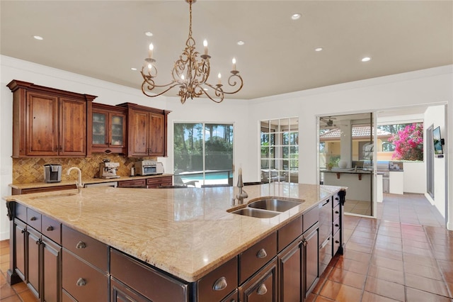 3130 Butler Bay Dr N, Windermere, FL 34786 - kitchen with a large island with sink, tasteful backsplash, light stone countertops, and recessed lighting