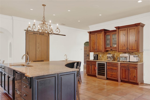 3130 Butler Bay Dr N, Windermere, FL 34786 - kitchen featuring beverage cooler, arched walkways, a center island with sink, tasteful backsplash, and recessed lighting