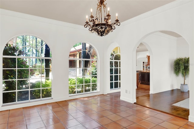 3130 Butler Bay Dr N, Windermere, FL 34786 - unfurnished dining area with healthy amount of natural light, tile patterned floors, crown molding, a chandelier, and arched walkways