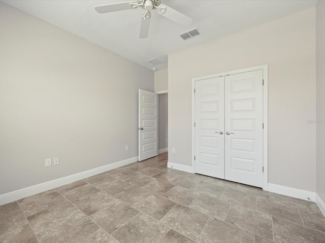 1709 Benoit Ter, Davenport, FL 33837 - unfurnished bedroom featuring stone finish floors, a closet, and ceiling fan