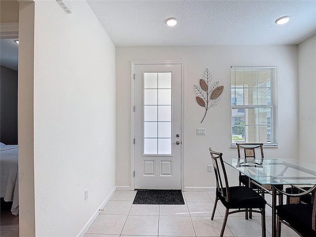 129 Boydfield Ln, Davenport, FL 33837 - entryway with light tile patterned floors, recessed lighting, and a textured ceiling
